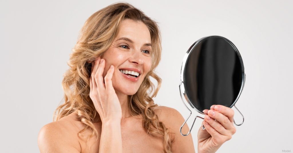 Woman smiling after treatment for facial brown spots (model)